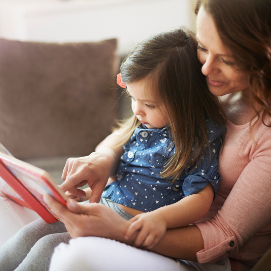 73_9282_16Dec2024095115_Woman reading a  book to a young girl 540px.png